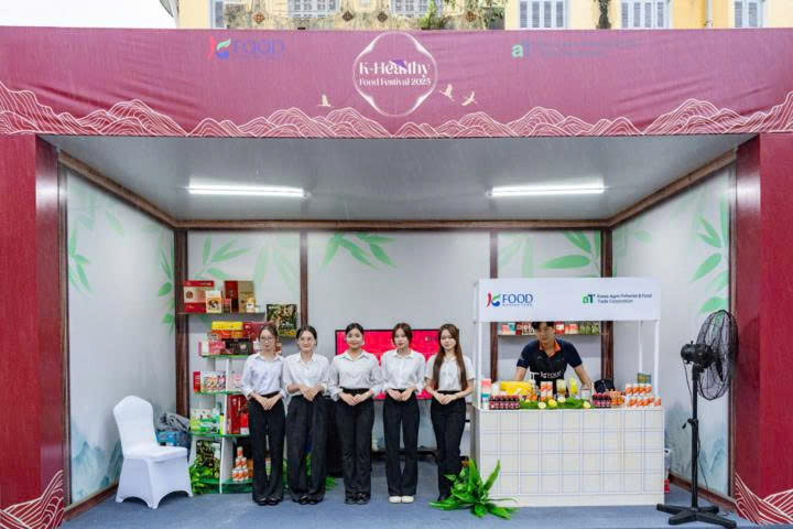 A group of people standing in a boothDescription automatically generated